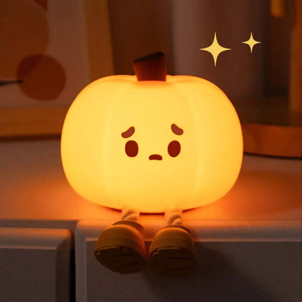 Cute Pumpkin Night Light with a face on a shelf.